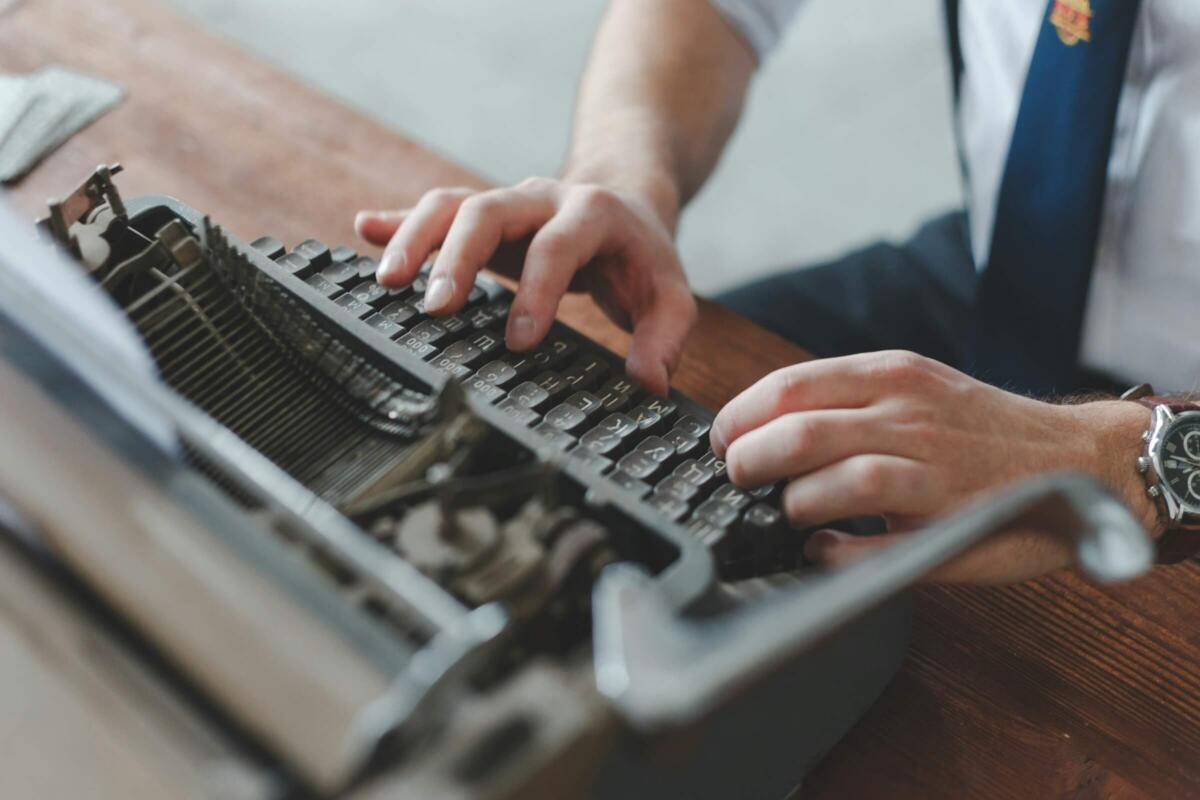 Man operating a typewriter, representing copyright law